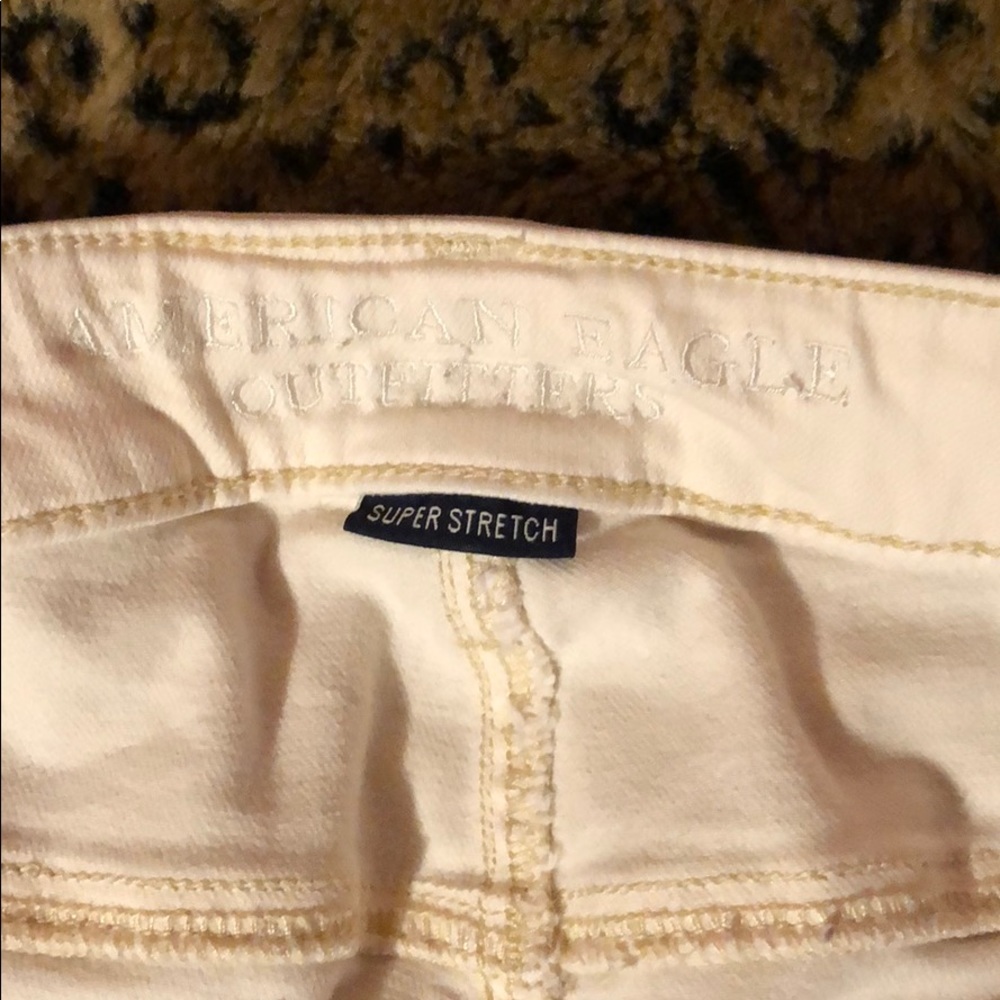 AE OFF WHITE RIPPED JEANS.